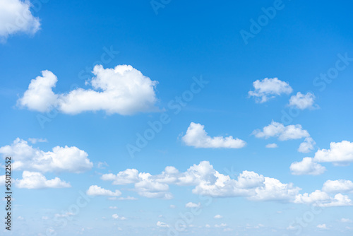 Photography Blue sky background with small clouds.