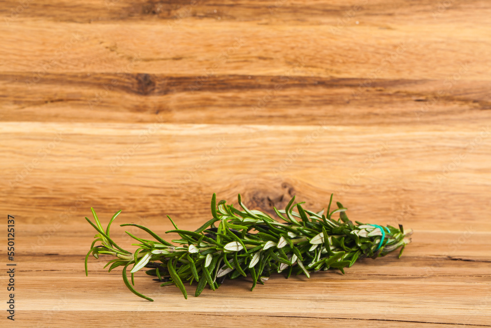 Rosemary on a wooden background. Rosemary on a wooden background.