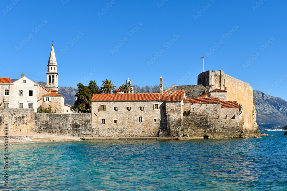 Beautiful coast and the old town of Budva, Montenegro. Adriatic sea water, blue sky