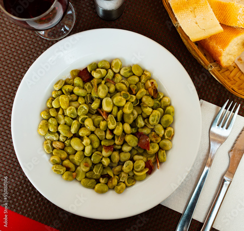 Delicious Catalan style beans cooked with pieces of jamon and spices. Popular dish of national cuisine..