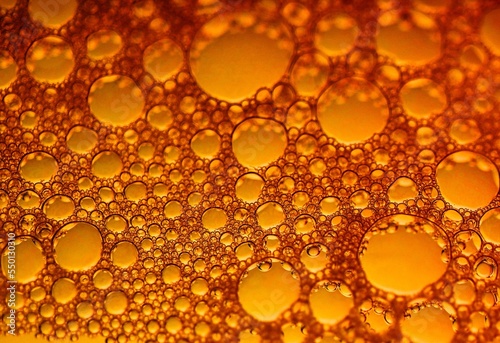 Close-up of many bubbles in water with orange, golden color background. Art, abstract.