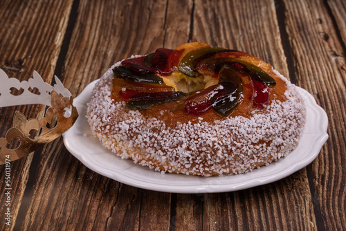 Rosca de reyes, king cake, glazed fruit, Provencal Galette des rois on a wooden table