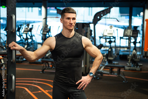 muscular athlete in fitness gym. muscular athlete in sportswear. sport and fitness. muscular athlete