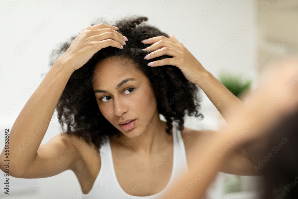 Portrait of a beautiful young woman examining her scalp and hair in front of the mirror, hair roots, color, grey hair, hair loss or dry scalp problem Stock Photo | Adobe Stock Portrait of a beautiful young woman examining her scalp and hair in front of the mirror, hair roots, color, grey hair, hair loss or dry scalp problem Stock Photo | Adobe Stock