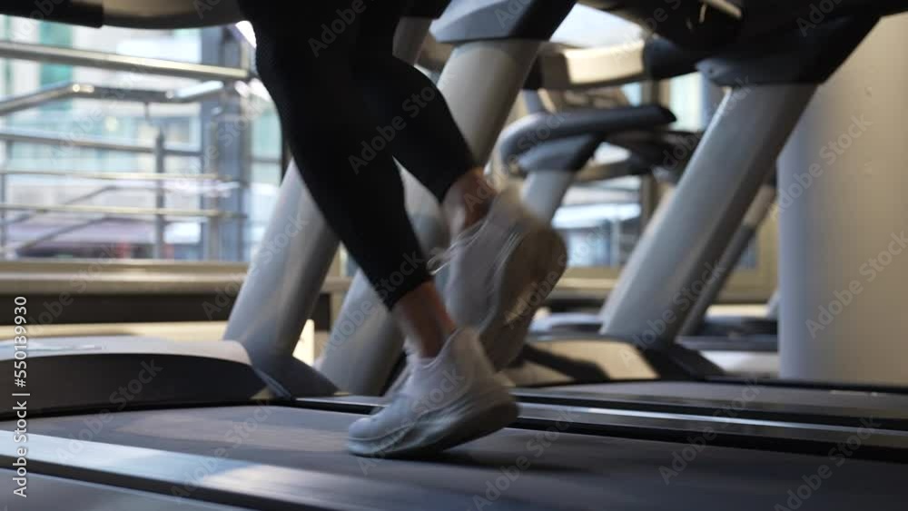 sportsman running on fitness treadmill in gym. Treadmill workout of sportsman. Fitness gym equipment