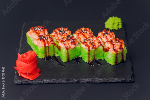 Traditional japanese food, Mix colorful sushiSet of different kinds of sushi rolls with salmon, shrimp and vegetables. On black rustic background. Top view. photo