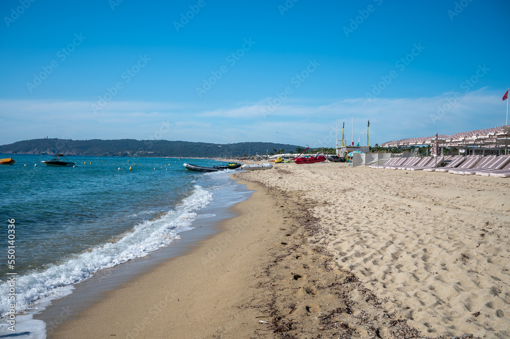 Crystal clear blue water of legendary Pampelonne beach near Saint-Tropez, summer vacation on white sandy beaches of French Riviera, France