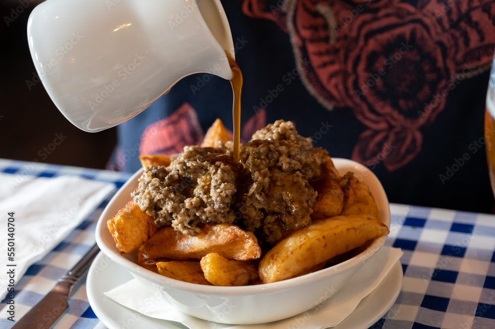 Scottish traditional snack food, hand cut potato chips topped with