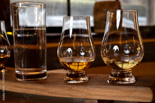 Flight of single malt scotch whisky in glasses served in whiskey bar in Edinburgh, UK