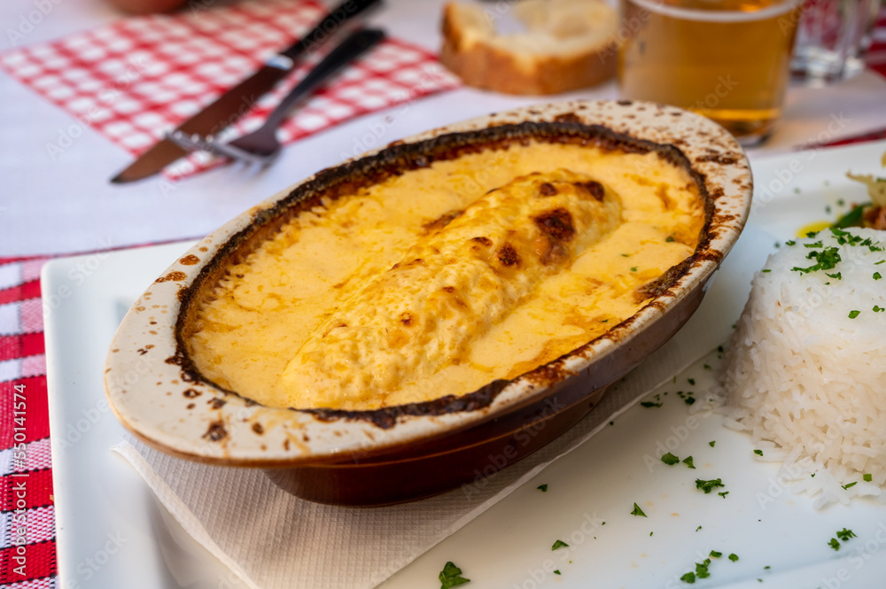Quenelle, speciality of Lyon, oval-shaped dumplings filled with pike white fish served in creamy sauce in traditional Lyonnaise Bouchon, France