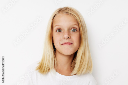 happy child with blond hair on a light background