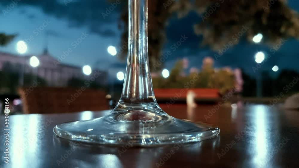 glass of wine on the table in night lights background glass of wine on the table in night lights background