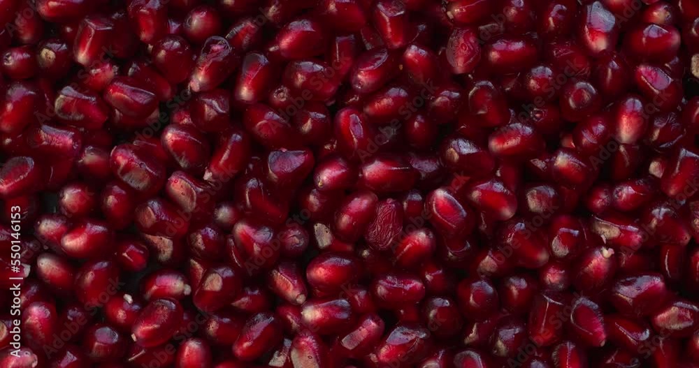 Close-up background texture pattern view of pomegranate fruit seeds (grain). Table spin. Close-up background texture pattern view of pomegranate fruit seeds (grain). Table spin.