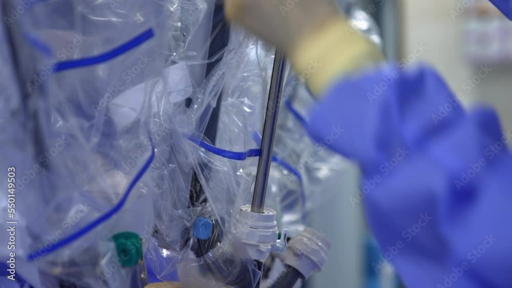 Getting ready the robotic surgery equipment for work at operational room. Hands in latex gloves adjoining the parts of robotic arms. Close up. Getting ready the robotic surgery equipment for work at operational room. Hands in latex gloves adjoining the parts of robotic arms. Close up.