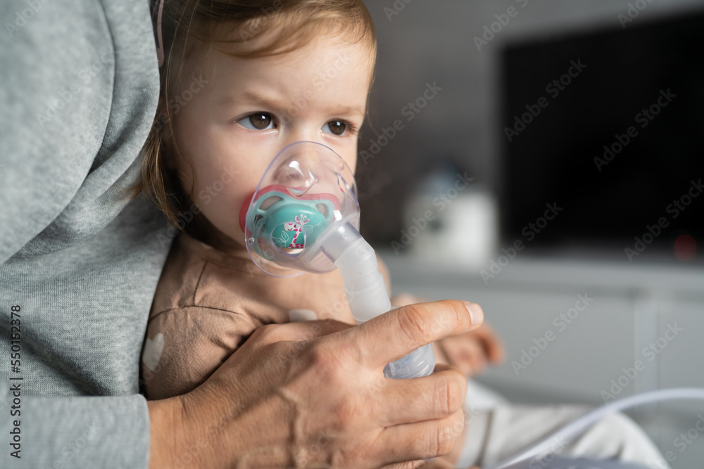 one child toddler girl using steam inhaler nebulizer at home