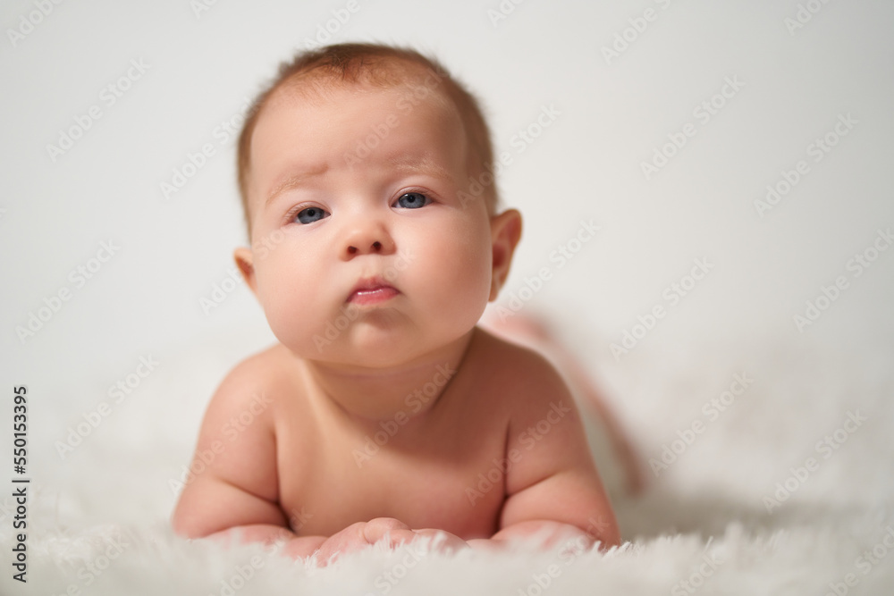 portrait of an infant with nonchalant haughty emotion on a white background portrait of an infant with nonchalant haughty emotion on a white background