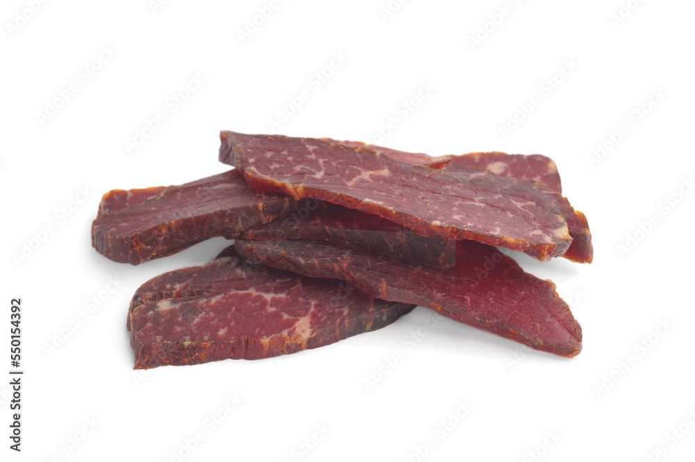 Pieces of delicious beef jerky on white background