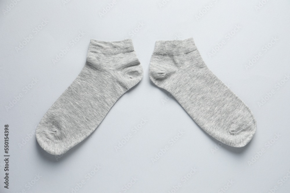 Pair of socks on light grey background, flat lay Pair of socks on light grey background, flat lay