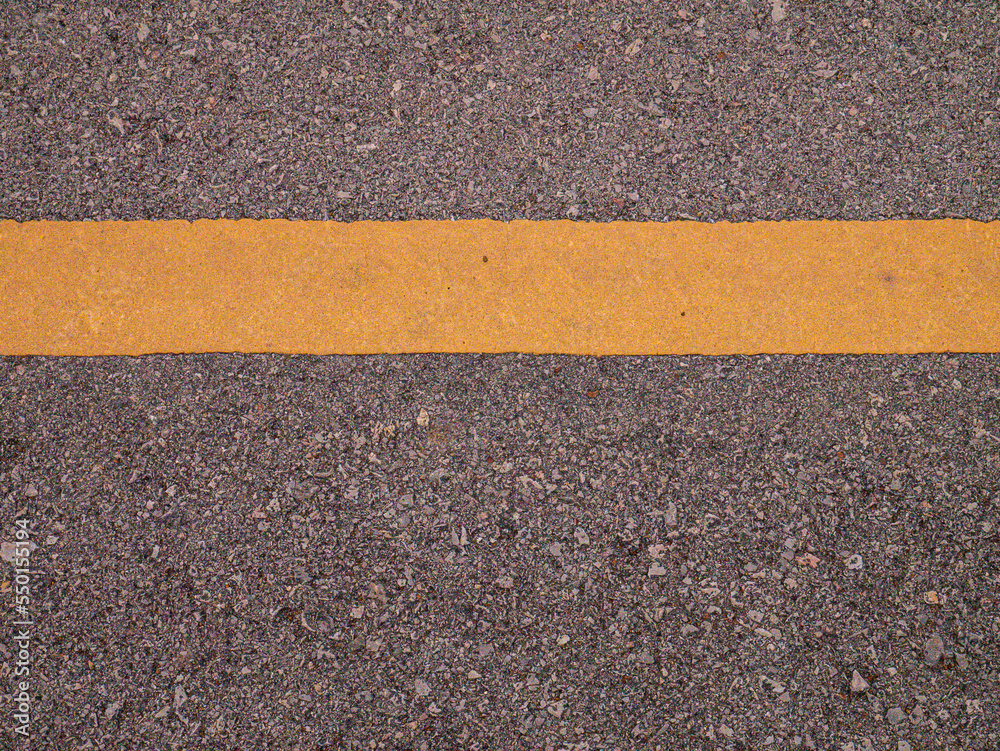 Fototapeta premium The asphalt and yellow line flat lay image for background or texture concept
