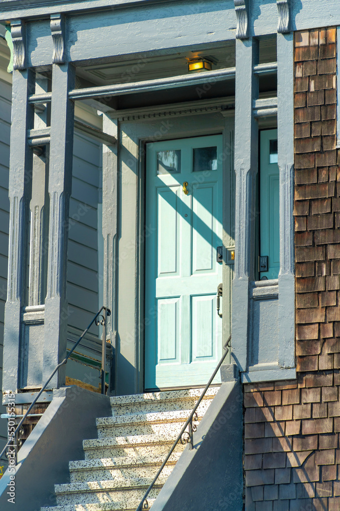 Light blue painted front door with dark grey timber framing and cement ...