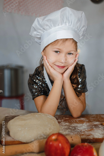 little girl cook in dough cap