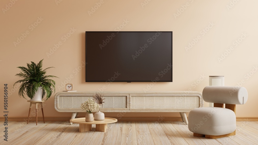 TV mockup in home interior with armchair and decor on cream color wall.