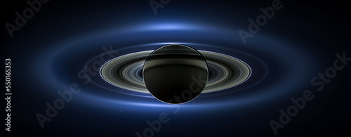 The planet Saturn in outerspace, showing its seven moons and rings. The sun is behind Saturn causing an eclipse. Digitally enhanced. Elements of this image furnished by NASA.