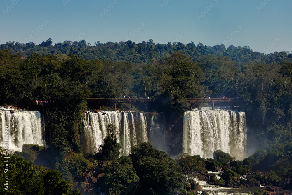 Tourists walk across a platform at Iguazú Falls