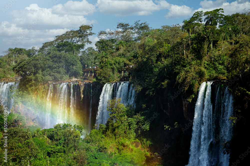 Naklejka premium Tourists walk across a platform at Iguazú Falls