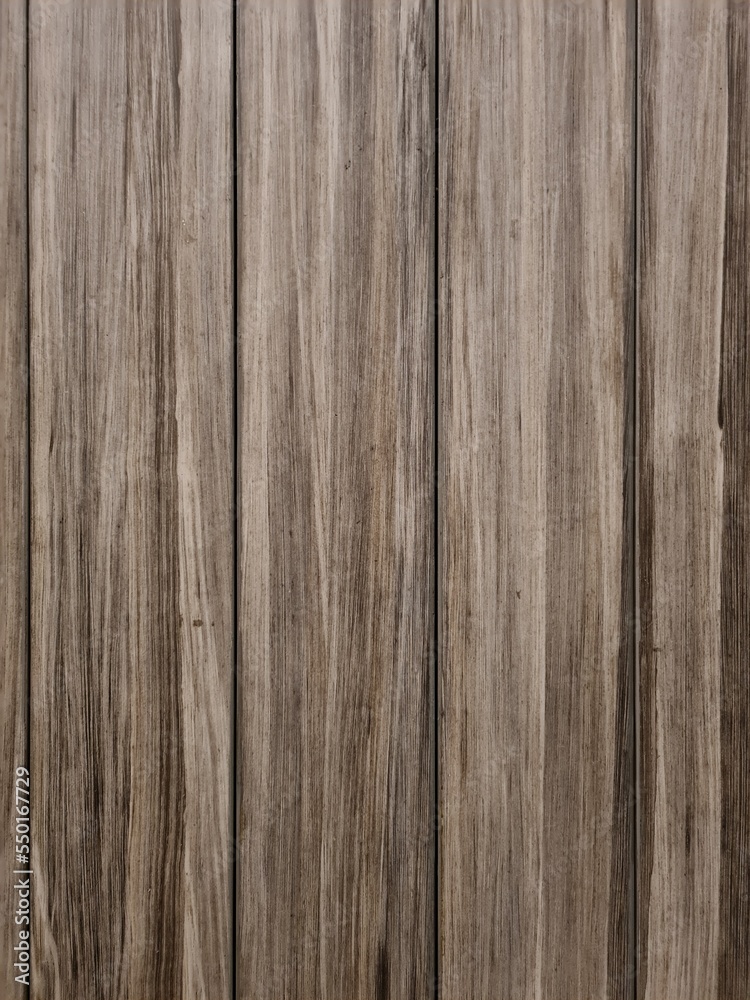 dark brown wood grain texture wallpaper. There is light and shadow on the surface. dark brown wood grain texture wallpaper. There is light and shadow on the surface.