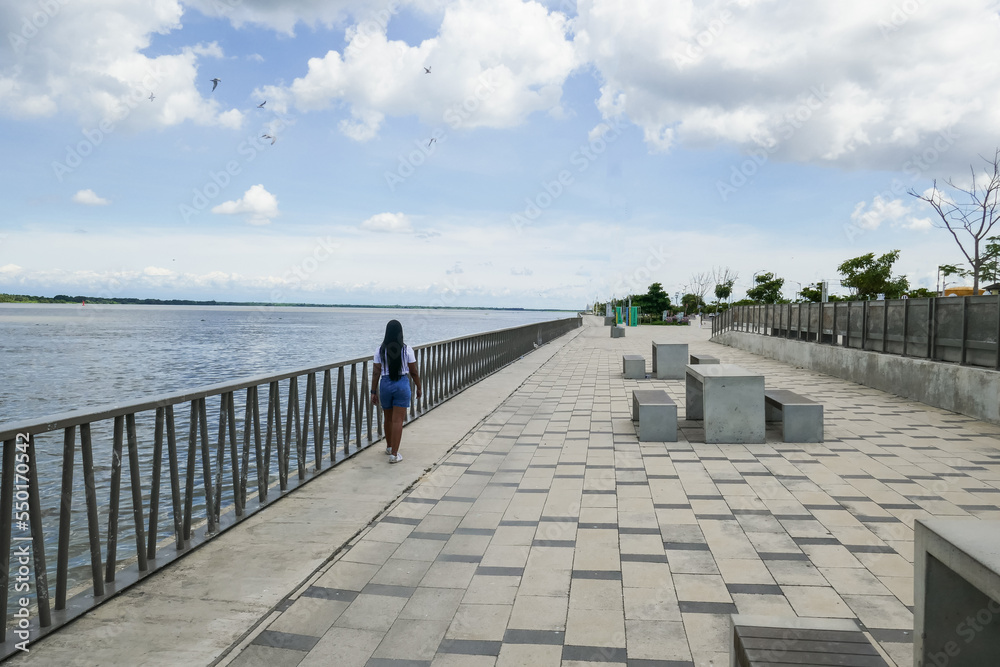 Tourist walking along the promenade and the Magdalena river. Barranquilla, Colombia