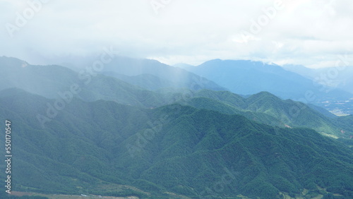 The raining mountains view with the foggy and misty raining droplets