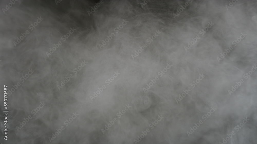Abstract white puffs of smoke swirls overlay on black background pollution. Royalty high-quality free stock photo image of abstract smoke overlays on black background. White smoke swirl fragments