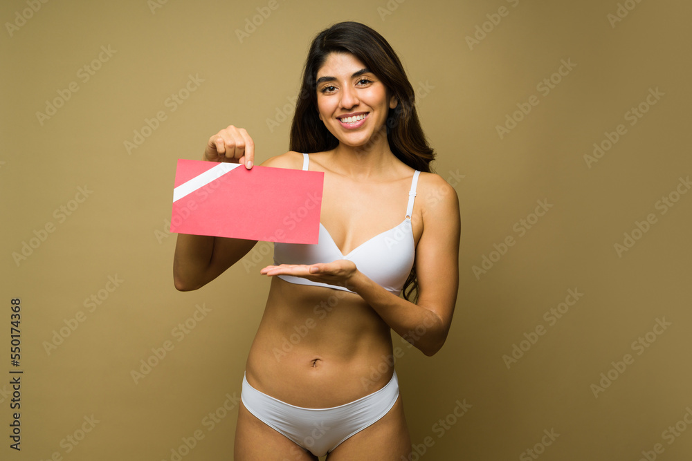Fototapeta premium Beautiful young woman with a cosmetic procedure gift card