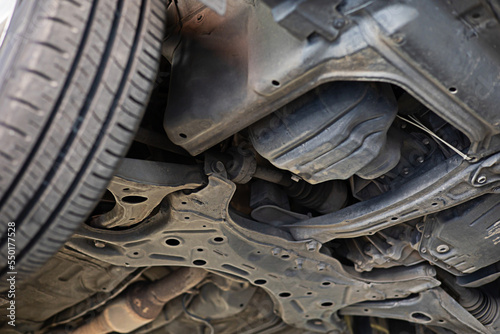 image of the underside of the car being lifted with a jack to check the condition of maintenance for safety according to use