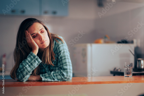 Bild auf Leinwand Tired Woman Feeling Sleepy Wearing Pajamas in her Kitchen