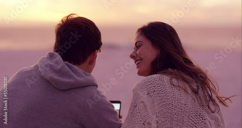 Couple, kiss or phone on sunset beach in romantic holiday, honeymoon vacation or summer break and social media app. Smile, happy or talking man and bonding woman by sea or ocean and mobile technology photo