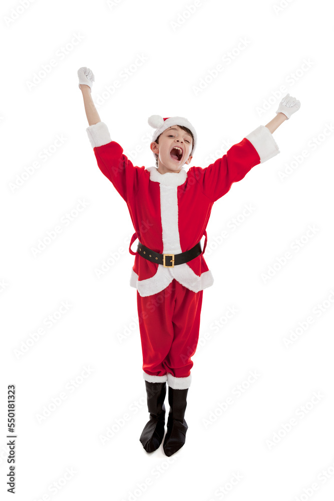 Full length portrait of an adorable 10 year old boy dressed in a Santa costume with arms in the air cheering isolated on a white background Full length portrait of an adorable 10 year old boy dressed in a Santa costume with arms in the air cheering isolated on a white background