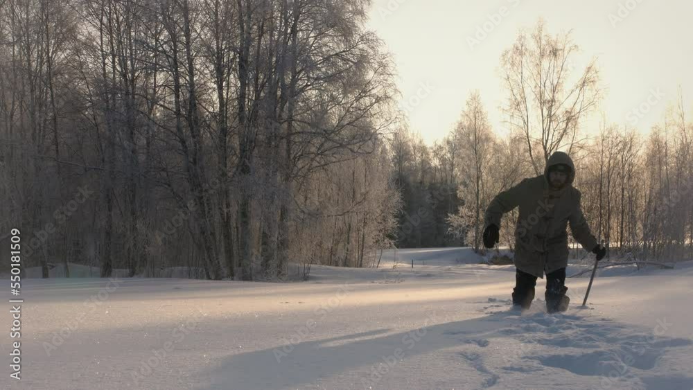 Man walking with difficulties on path covered by lot of snow. Long way home. Static Man walking with difficulties on path covered by lot of snow. Long way home. Static