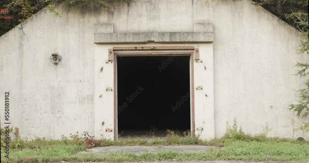 Closeup of the darkened doorway of an abandoned underground nuclear bunker in a remote area of the former Loring Air Force base near Limestone, Maine. Closeup of the darkened doorway of an abandoned underground nuclear bunker in a remote area of the former Loring Air Force base near Limestone, Maine.