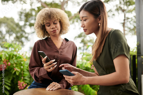 Woman Showing Application to Friend