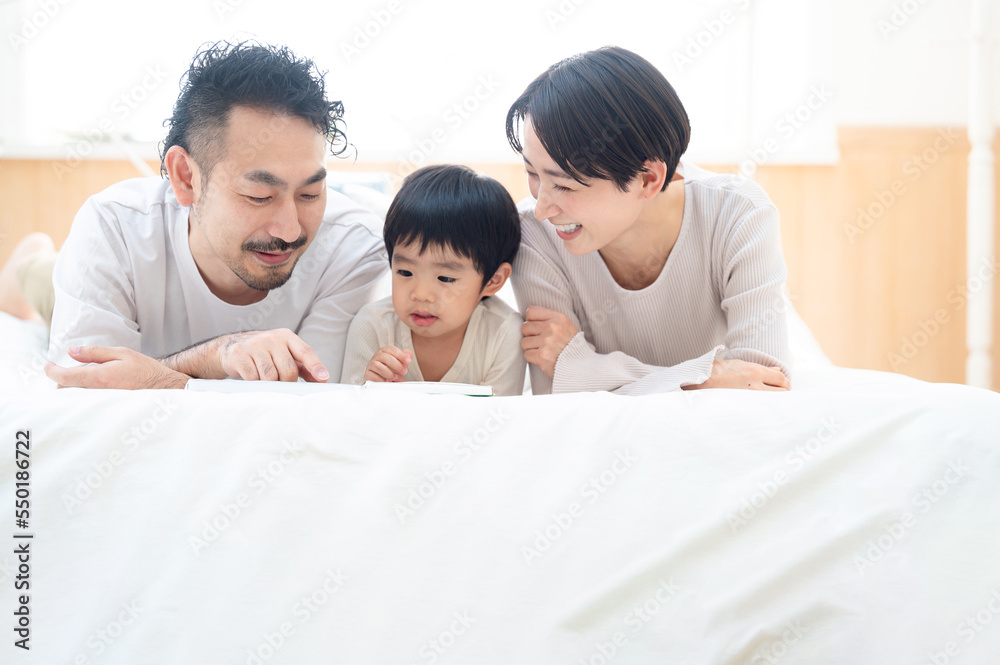 Asian family relaxing in their bedroom Asian family relaxing in their bedroom