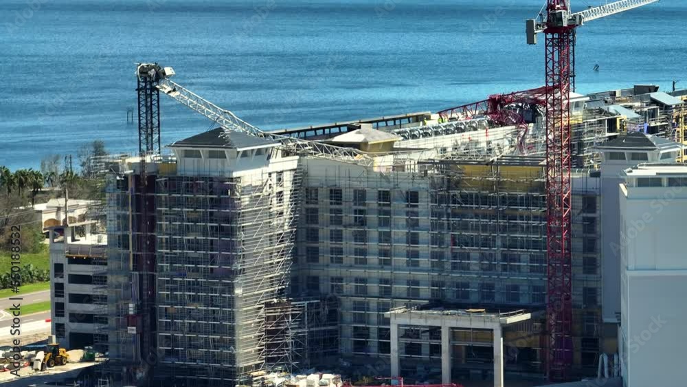 Aerial view of ruined by hurricane Ian construction crane on high apartment building site in Port Charlotte, USA Aerial view of ruined by hurricane Ian construction crane on high apartment building site in Port Charlotte, USA