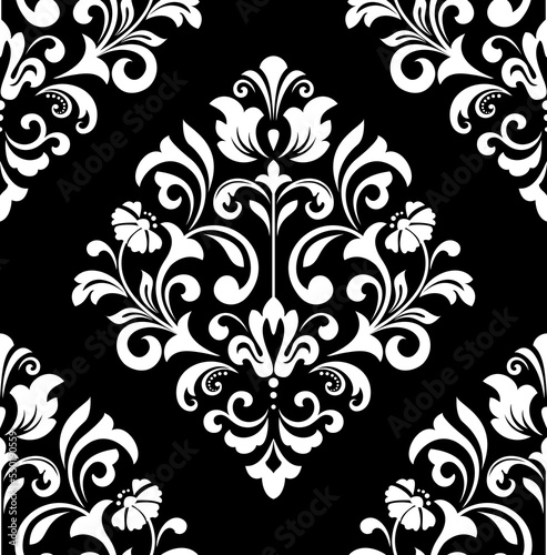 Wallpaper in the style of Baroque. Seamless vector background. White and black floral ornament. Graphic pattern for fabric, wallpaper, packaging. Ornate Damask flower ornament