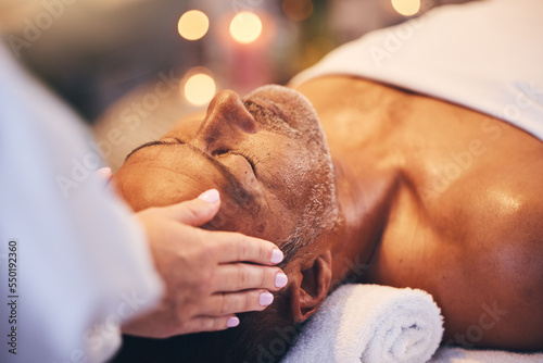 Hands, old man and head massage at spa for wellness, relax and health. Bokeh, peace and zen with elderly male on massage table with masseuse for stress relief, facial treatment or physical therapy.