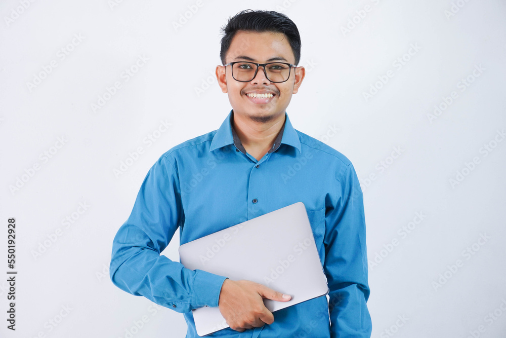 smiling or happy asian businessman with glasses holding laptop wearing blue shirt isolated on white background smiling or happy asian businessman with glasses holding laptop wearing blue shirt isolated on white background