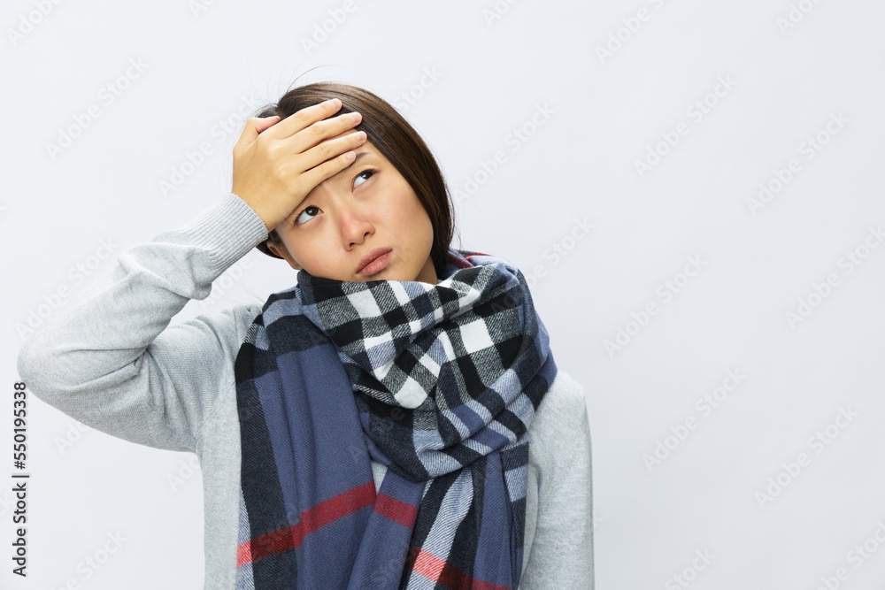 Asian woman cold flu raised hands from headache with fever sick from covid 19 virus on white background, copy space Asian woman cold flu raised hands from headache with fever sick from covid 19 virus on white background, copy space