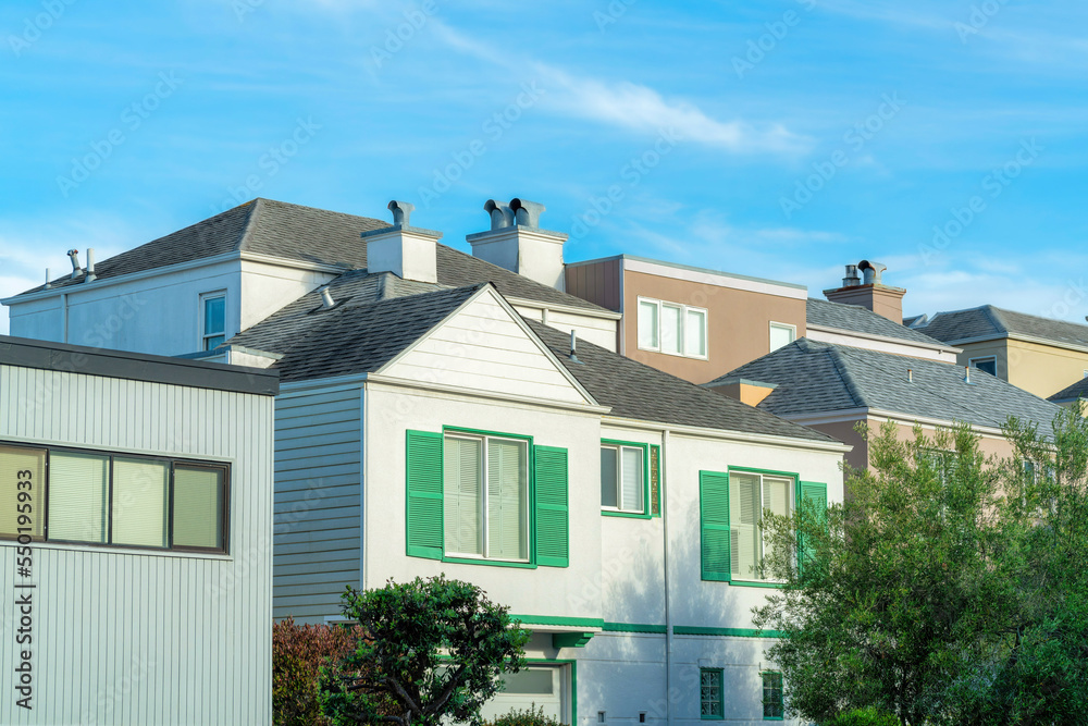 Row of modern house facades with decorative roofs in family neighborhood in San Francisco California