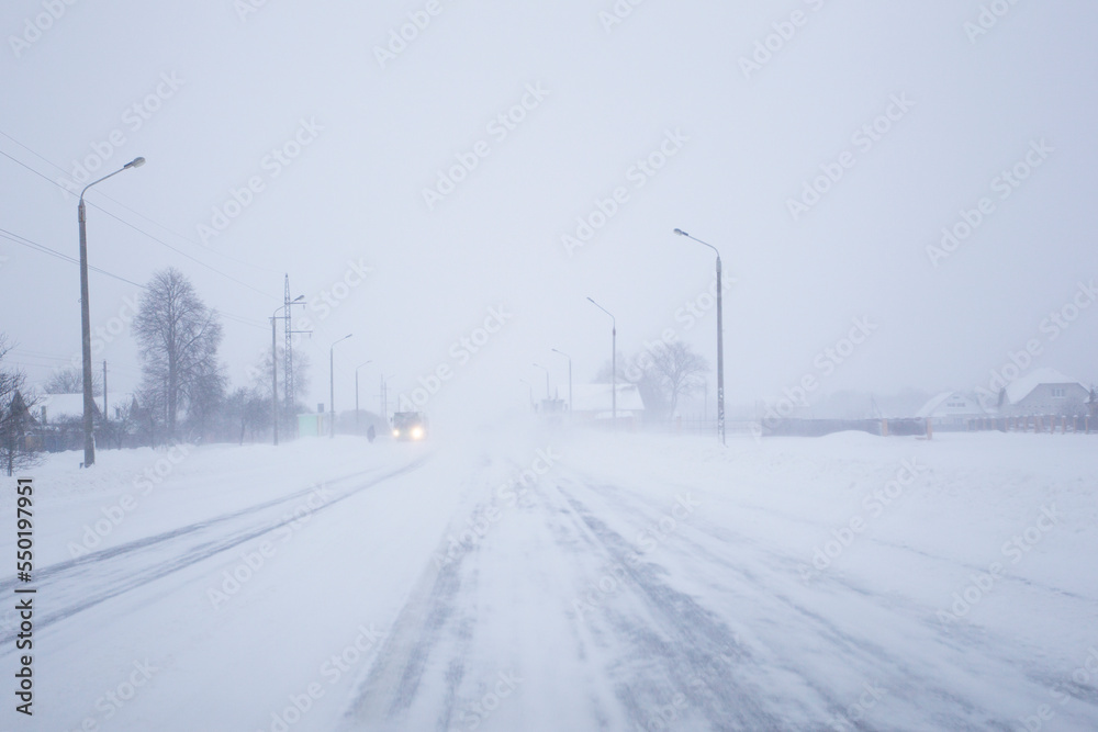 Snow covered foggy road in bad winter weather. Snow covered foggy road in bad winter weather.