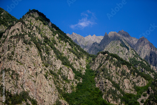 Rocky mountains with vegetation against the sky. Mountain landscape.